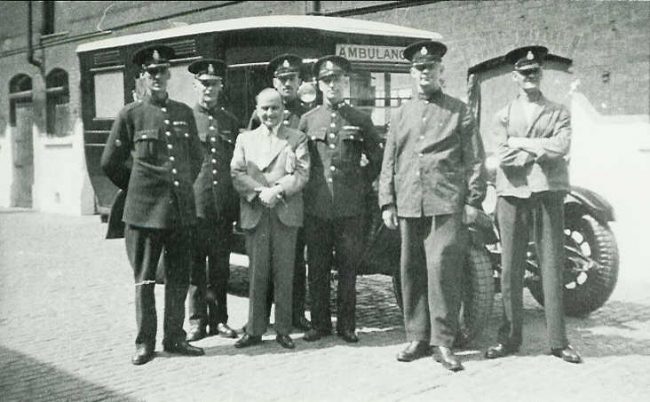 Police Austin ambulance at Central Fire Station, Park Road, Portsmouth (now King Henry I Street) PC Syd Boyland is far left.